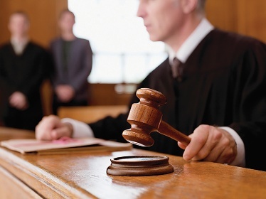 Judge in court holding a gavel.